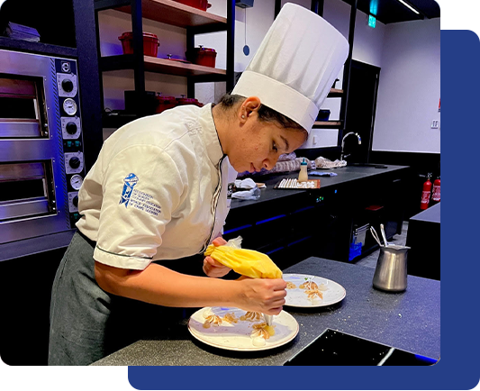 A student completing a culinary internship in France, gaining hands-on experience in French cuisine during their prestigious culinary internship in France.